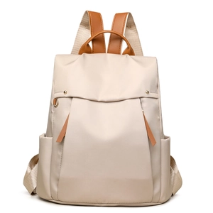 Minimalist canvas laptop backpack in beige with brown leather accents and side pockets