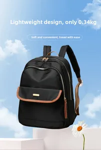 Detail of lightweight black nylon backpack weighing only 0.34kg with gold metal zippers