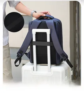 Deep blue backpack detail showing breathable mesh back and luggage strap on a suitcase