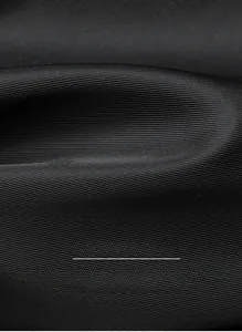 Macro detail of black high-strength fabric with durable texture for travel backpack