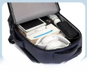 Interior view of navy business backpack showing main compartment with laptop and accessories