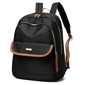 Classic black nylon backpack with brown leather trim and golden zippers in 45-degree view