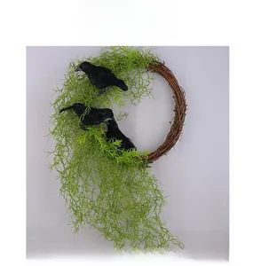 Detail of Halloween wreath featuring lifelike black crows and drooping green leaves on vine