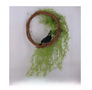 Detail view of the back of a Halloween wreath featuring green artificial vines and a black crow