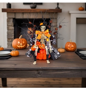 Detailed Halloween skeleton figurine in orange tuxedo sitting on a glittery pumpkin base