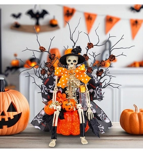 Detailed Halloween skeleton decor with orange pumpkins and festive ribbons on black branches