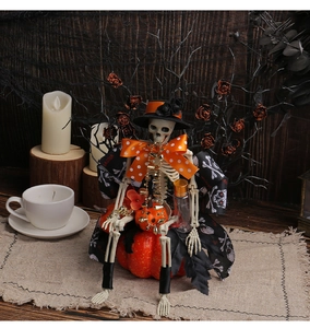 Halloween skeleton in black cloak sitting on pumpkin with festive party background