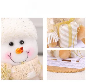 Detail of plush snowman decoration with white glitter hat and star pattern scarf on a sled