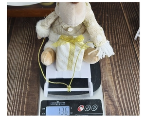 Christmas reindeer plush figure with gold sweater on white sleigh weighing 136g