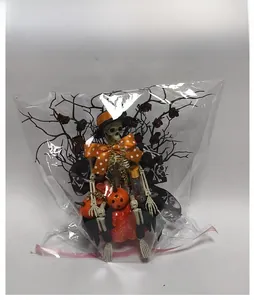Halloween skeleton and pumpkin decor with dead branches in retail transparent packaging