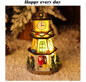 Close-up of lighted Christmas resin clock tower with Santa Claus and festive LED glow