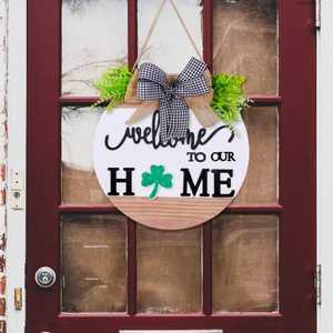 Round wooden Welcome Home sign with clover leaf and rustic bow for front door decor