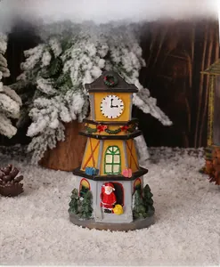 Detailed view of LED glowing Christmas resin clock tower with Santa Claus figurine