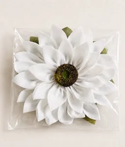 Detail view of handmade burlap sunflower decor in transparent protective packaging