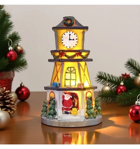 Detailed view of LED lighted Christmas clock tower with Santa Claus and festive decor