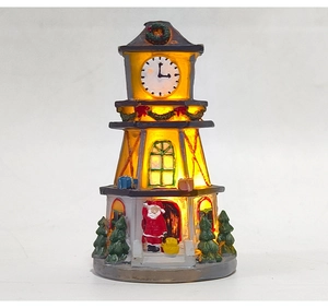 Detailed view of LED lighted Christmas clock tower with miniature Santa Claus figure