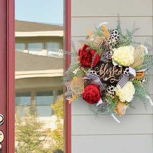 Front door floral wreath with 'blessed' sign, peonies, and patterned ribbons decor