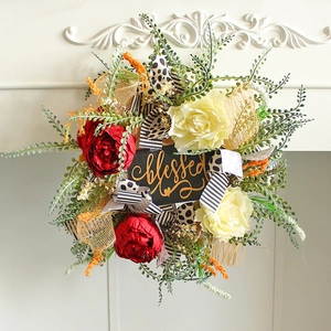 Floral wreath with roses and blessed sign on a white fireplace home decoration