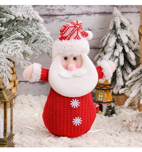 Detail of knitted Santa gift bag with white snowflakes and festive nordics cap decoration