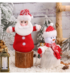 Close-up of knit Christmas candy bags featuring Santa and snowman with fluffy textures