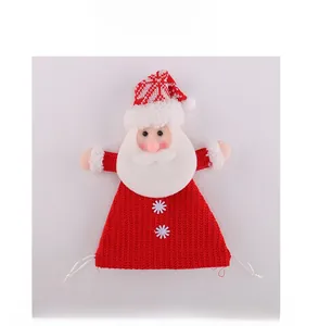 Detail of Santa Claus knitted Christmas gift bag with festive red and white patterns
