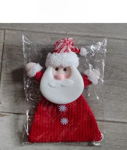 Detail view of a knitted Santa Claus candy gift bag in clear plastic packaging