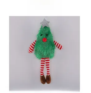 Macro shot of plush Christmas tree doll with red-white striped legs and silver star top