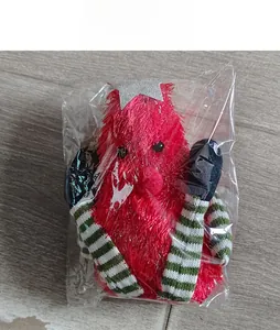 Detailed view of a long-legged Christmas gnome plush doll in clear plastic packaging