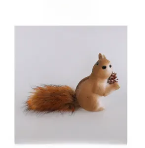 Front view of a realistic woodland squirrel ornament holding a natural brown pine cone