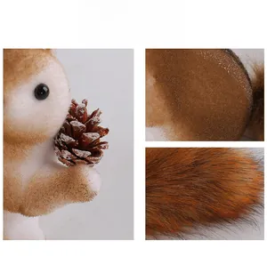 Detailed view of flocked squirrel ornament showing fur texture and pinecone accessory