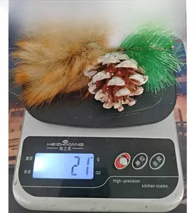 Detail view of small squirrel Christmas ornament weighing 21 grams on a digital scale