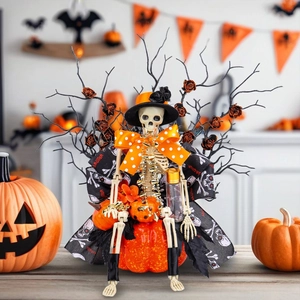 Halloween skeleton figure in a witch hat and lace dress sitting on a pumpkin base decoration
