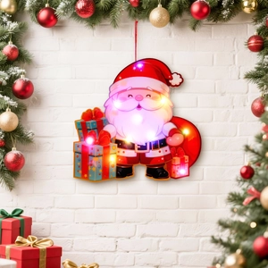 Illuminated Santa Claus LED window light decoration with warm glowing gift bag design
