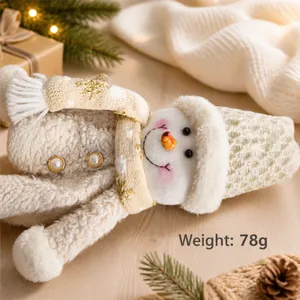 Detail shot of plush snowman wine bottle cover being weighed, showing 78g on scale