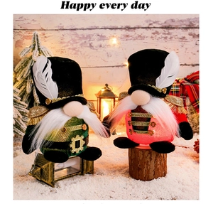Detail of Christmas soldier gnomes with sequins, gold tassels and feather hats in warm decor