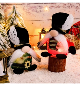 Detail of nutcracker gnomes with velvet hats, gold trim, and LED lights for Christmas