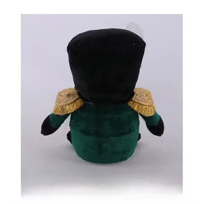 Rear view of festive soldier doll featuring dark green velvet and gold tassel epaulettes