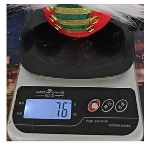 Detail showing the exact 76g weight measurement of the Christmas gnome doll on a digital scale