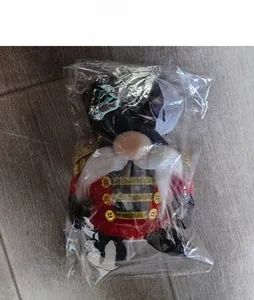 Detailed view of nutcracker gnome Christmas soldier doll in transparent packaging bag