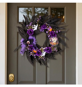 Detail of Halloween wreath with purple roses, ghost charms, and Happy Halloween sign on door