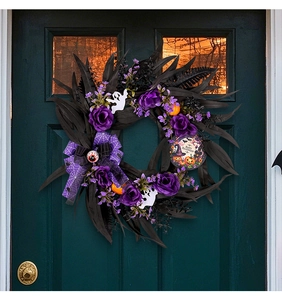 Detail of Halloween wreath with purple roses, black leaves, and Happy Halloween sign