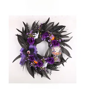 Macro detail of Halloween wreath with purple roses, black leaves, and pumpkin decor