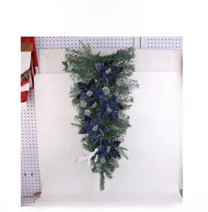 Deep blue Christmas teardrop swag with velvet poinsettias and frosted snowflakes