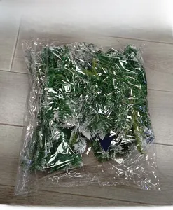 Detail of snowy artificial pine branches for Christmas decoration packed in a clear bag