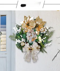 Detail view of a religious Christmas wreath with golden poinsettias and Holy Family image