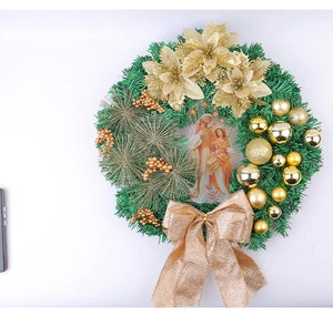 Detailed Christmas wreath with golden poinsettias, festive baubles and holy family icon