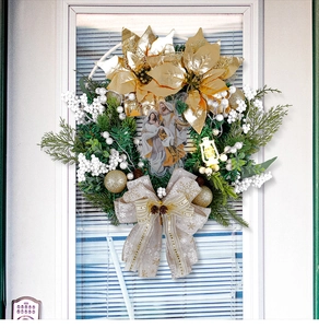 Detail of Christmas wreath with golden poinsettia, Holy Family sculpture and champagne bow
