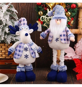 Close-up of blue plaid reindeer and Santa plush toys with snowflake embroidery