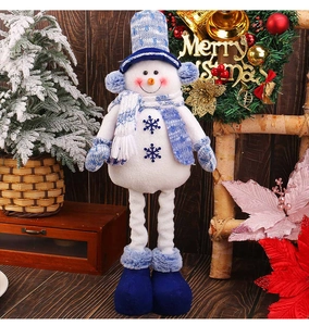 Close-up of plush Christmas snowman with blue snowflake embroidery and long legs