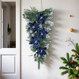Blue velvet poinsettia teardrop swag with flocked pine needles and silver pinecones